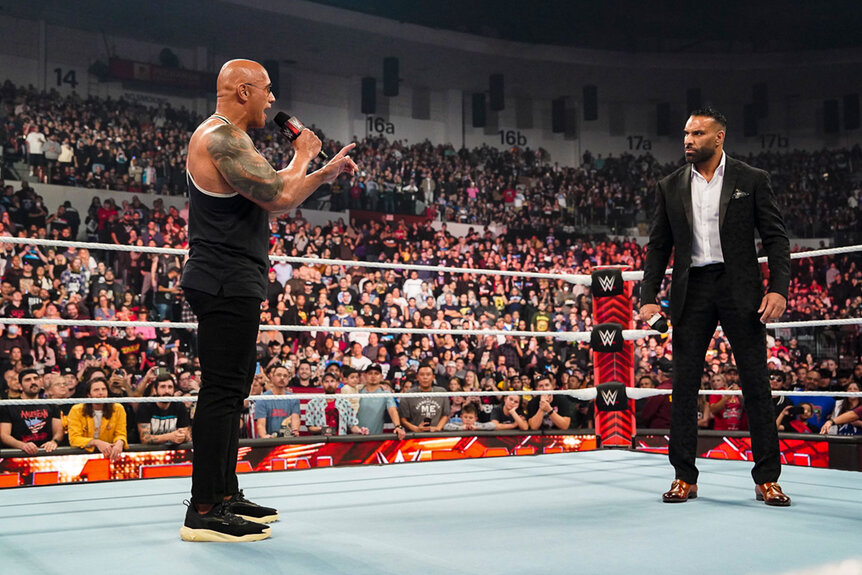 The Rock speaks while standing in the ring