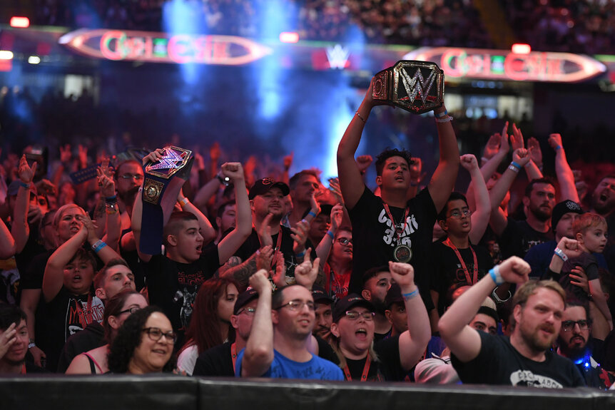 The Wrestlemania crowd reacts to a match happening in the ring