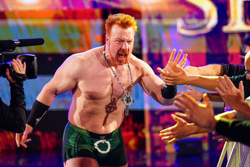 Sheamus high fives the crowd as he walks to the ring
