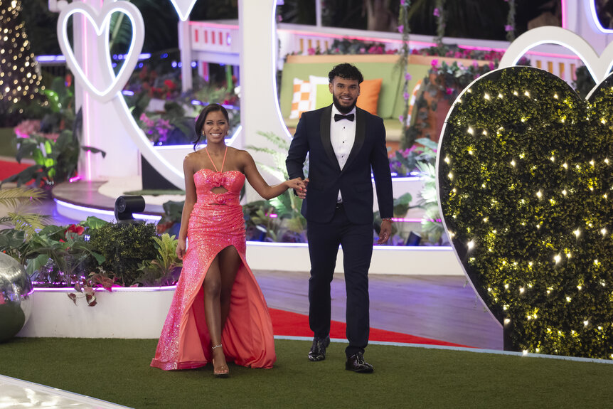Love Island USA Season 7 winners Amaya Espinal and Bryan Arenales walk to the finale in the villa.