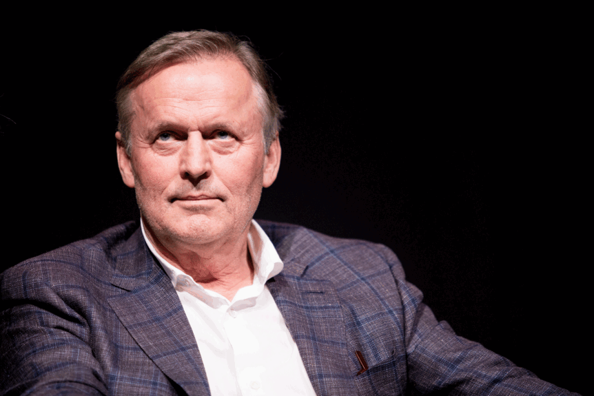 John Grisham appears with a black background