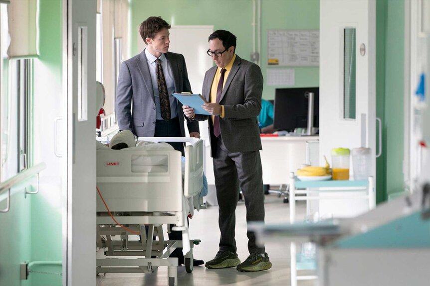 The Rainmaker's Rudy and Deck looking at a file in the hospital